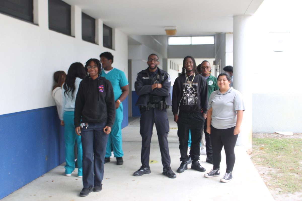GOING IN: Officer Terrell is showing his students what cops do and how to do it during a breech.