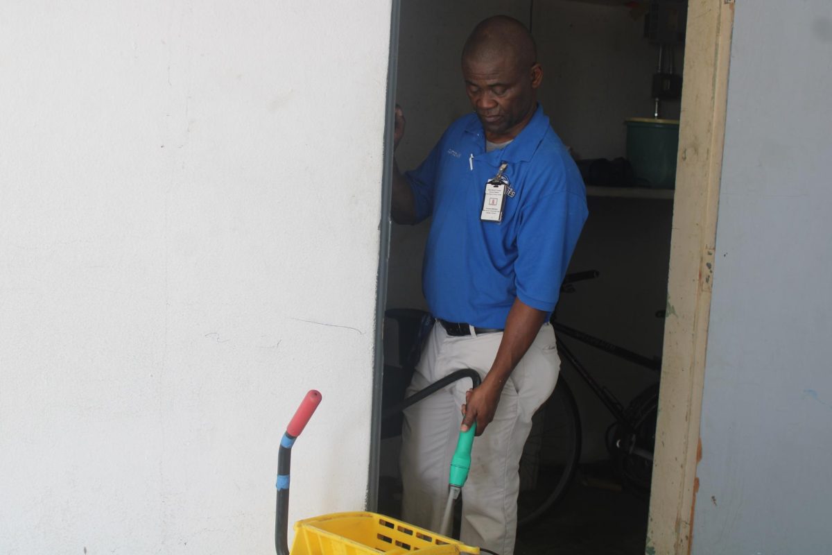 POLISHED ENVIRONMENT: This janitor works to tidy the school and rid it of its trash.