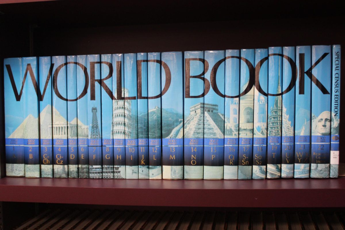 WORLD BOOK: A row of book lined up on the shelf spelling out something.