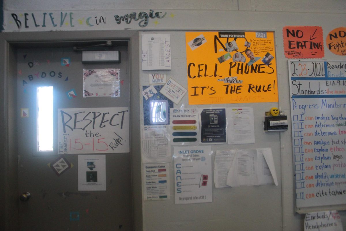 REMINDER: This teachers door is a colorful sight of rules and reminders.