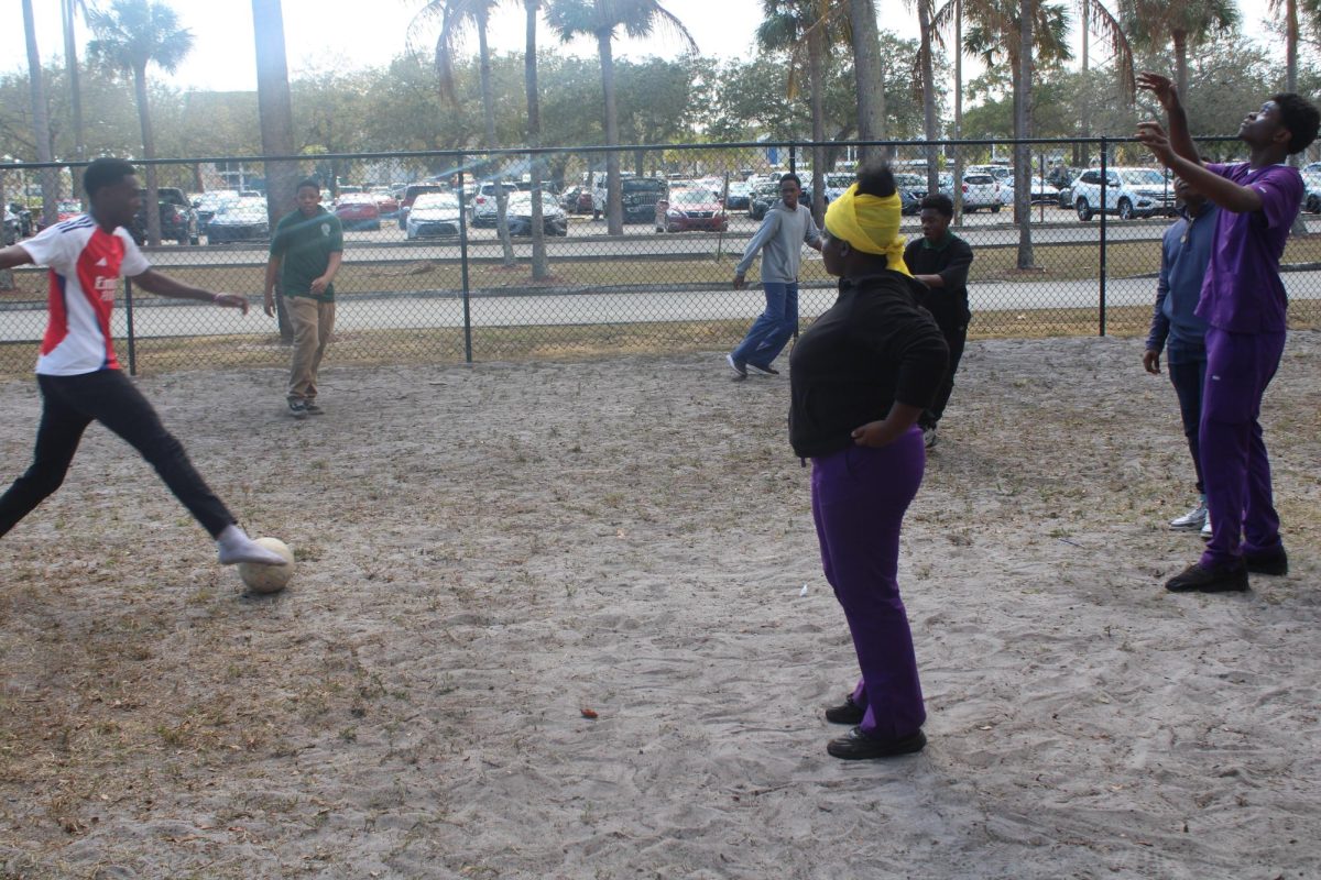 SHARE THE COURT: In the same field, a few kids play soccer nearby and interchangeably.