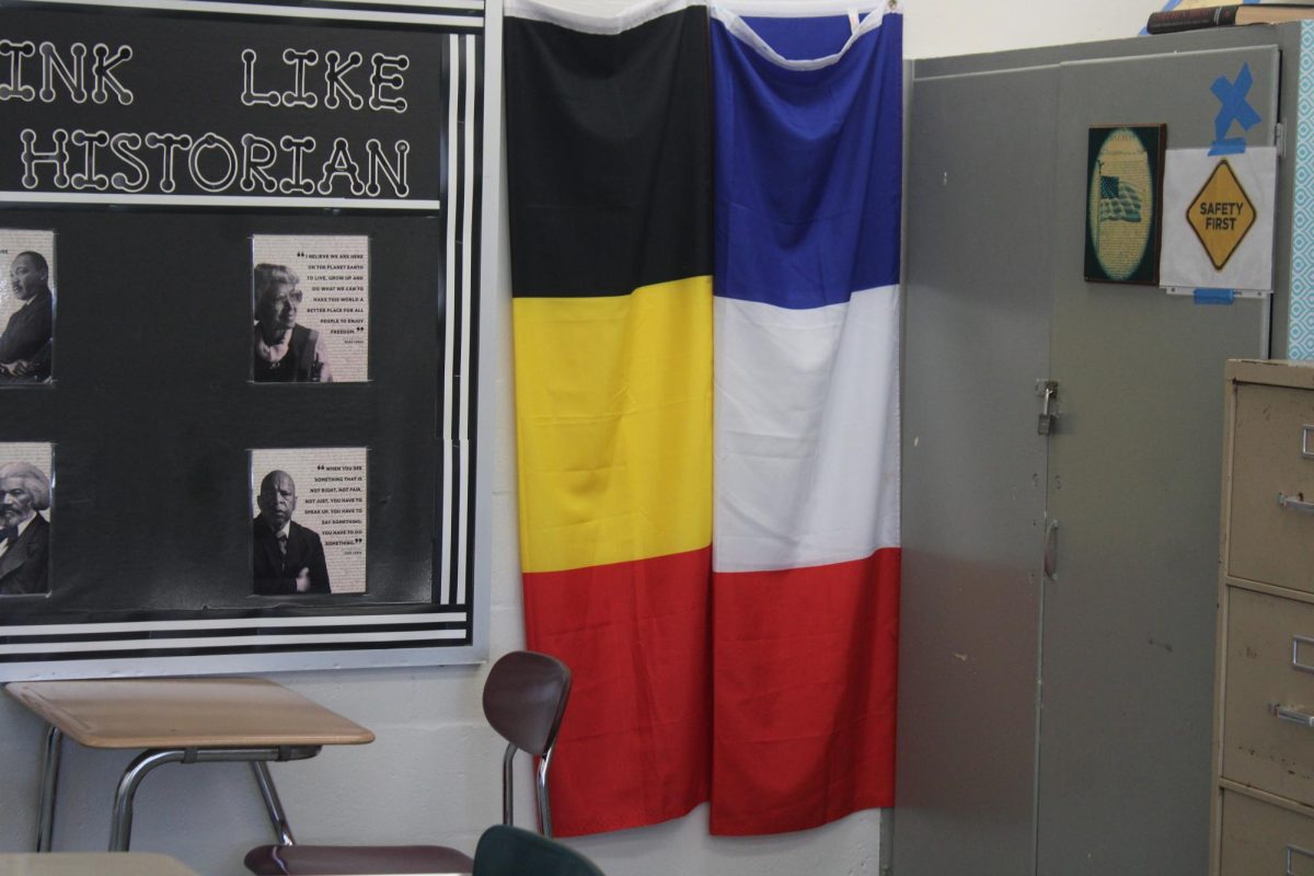 WAIT FOR IT: Before the big reveal, let's rotate around and show two flags the teacher has, a reminder of their travels.