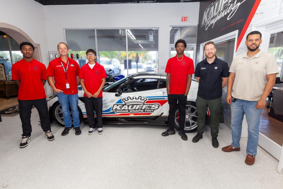 MEET THE TEAM: Mr. Haughn's Digital Design academy went on a field trip to Kauff's Signs, Wraps, & Tint. They met the two designers, who are also judging the three students in the photo, Jorden Black, Chandler Metelus and Xavi Paxtor-Vasquez, for the Future Generation Gala.