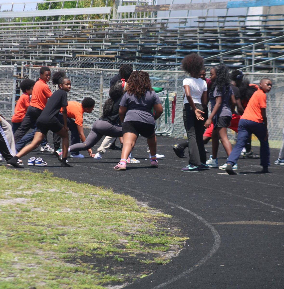 WARMING UP: Middle school students stretch and prepare for a run.