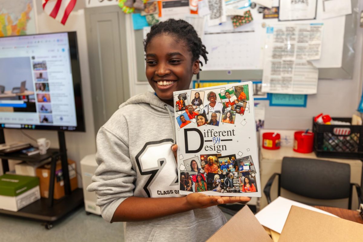 SNEAK PEAK: Lovely Marcelus, Editor in Chief, picks up the new yearbook to end of 2026 and gives two thumbs up. "I really like it," she said, "and I think other people will too." Yearbook will be up for sale tomorrow, Friday, during lunch.