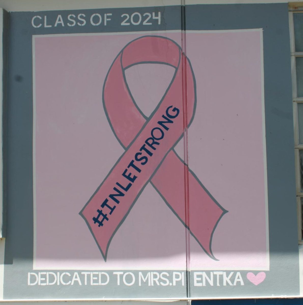 PINK FOR PIENTKA: The Senior Class of 2024 painted a memorial remembering the late Ms. Pientka. She served many roles, whether it was a history teacher, assistant principal, or Senior class advisor, she was loved by all. 
